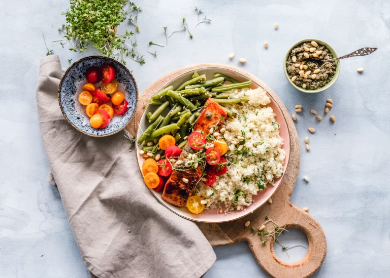 A grain bowl with roasted vegetables and fresh greens.